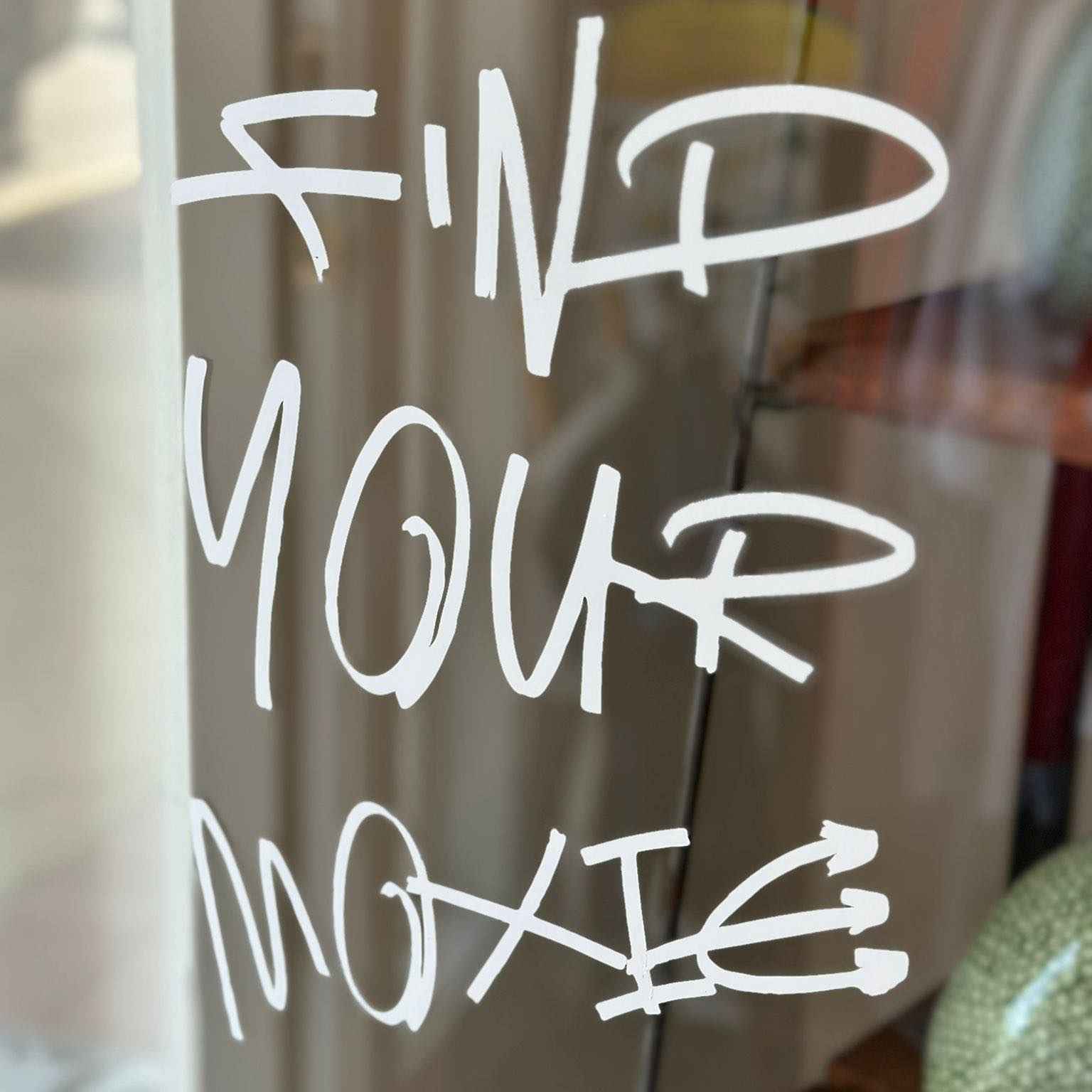 White text 'FIND YOUR MOXIE' on the window at MOxie in Bainbridge GA