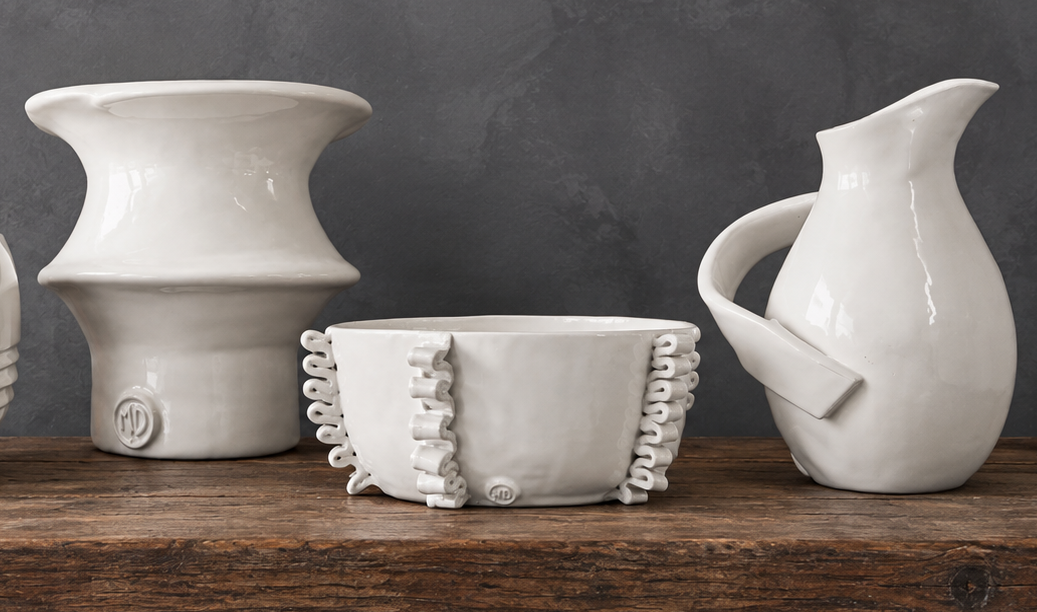 Montes Daggett Pottery on a rustic wooden counter at Moxie Boutique